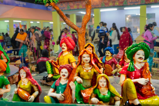 Kolkata, West Bengal, India - 31st December 2018 : Colorful male and female Terracotta dolls dressed in traditional Indian dresses, playing musical instruments, made in Krishnanagar, Nadia being sold.