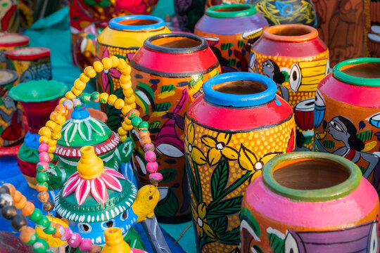 Beautiful painted colorful terracotta pots, works of handicraft, for sale during Handicraft Fair in Kolkata. Vertical image.