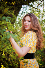 Happy girl with long hair walking in the spring