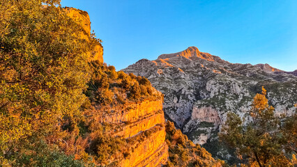 First sun beams during sunrise on summits of Monte San Michele, Molare, Canino, Caldare, Lattari Mountains, Apennines, Amalfi Coast, Italy, Europe. Hiking trail Path of Gods between Positano Praiano