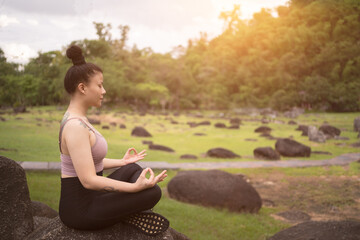 Naklejka na ściany i meble asian tattoo young woman doing yoga in the park