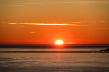 Panoramic sunset view from Praiano at Mediterranean Sea, Italy, Campania, Europe. Silhouette of Li Galli islands and horizon near Amalfi Coast. Reflection of sun beams on water surface during twilight