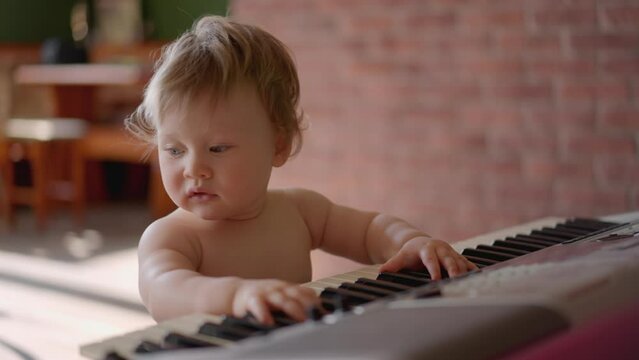 Asian Baby Girl Toddler Playing Electric Piano, Sit Down On The Floor Tapping On Keyboard Music Instrument, Kids Artistry Learning Skills, Happy Healthy Female Child Pretend To Play Music By Herself