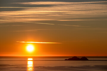 Panoramic sunset view from Praiano at Mediterranean Sea, Italy, Campania, Europe. Silhouette of Li Galli islands and coastline of Amalfi Coast. Reflection of sun beams on water surface during twilight
