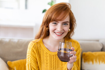 woman holding glass drinking natural water. Enough of quantity aqua improves skin complexion, increases energy, prevention of body dehydration, healthy lifestyle concept