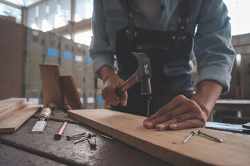 Carpenter working with equipment on wooden table in carpentry shop. woman works in a carpentry shop.