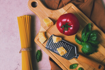 Raw pasta with ingredients, on a beige background, top view, rustic style, selective focus, no people.