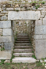 Detail of the entrance door and the main staircase built with large stones of an old manor house in ruins in Caldas de Luna province of León (Spain)