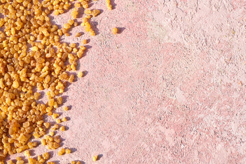 Frankincense resin crystals on pastel pink background with copy space