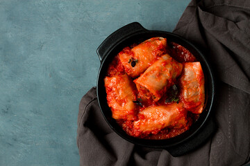 Stuffed cabbage rolls in tomato sauce, stuffed cabbage leaves, minced meat with rice, on a dark...
