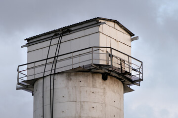 Observation tower. A water tower in front of a cloudy sky. Close up.