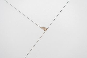 A chip at the junction of the laminate floor. Close up. The defect of the floor. Damage to the floor covering