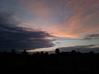 Fototapeta na wymiar 2 Types of Clouds in the Sky at Sunset (Black Cloud & Orange Cloud)