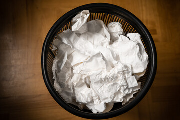 Handkerchiefs in the wastepaper basket after flu or a Corona or Covid-19 infection