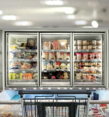 choosing a dairy products at supermarket.empty grocery cart in an empty supermarket