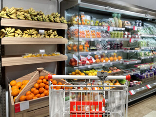 buying vegetables and fruits  at the market.empty grocery cart in an empty supermarket