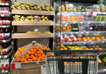 buying vegetables and fruits  at the market.empty grocery cart in an empty supermarket