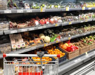 buying vegetables and fruits  at the market.empty grocery cart in an empty supermarket