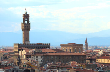 Fototapeta na wymiar Old Palace in Florence City in Italy and the Tower called TORRE Arnolfo di Cambio and rooftops