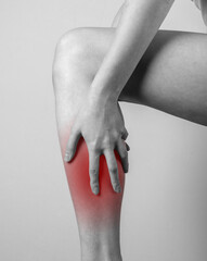 Shin pain. Woman holding leg with red spot. Tendons, muscles inflammation, injury, bone bruise...