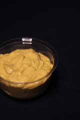 Cheddar cheese sauce for dipping chips bowl in dark background