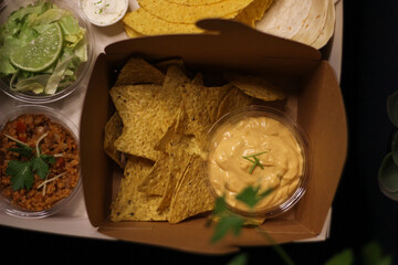 Nacho chips with cheddar cheese sauce for dipping snack mexican food style tex-mex