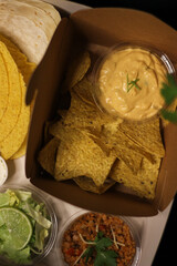 Nacho chips with cheddar cheese sauce for dipping snack mexican food style tex-mex