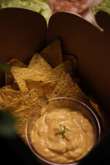 Nacho chips with cheddar cheese sauce for dipping snack mexican food style tex-mex