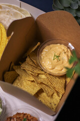 Nacho chips with cheddar cheese sauce for dipping snack mexican food style tex-mex