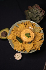 Nacho chips with cheddar cheese sauce for dipping snack mexican food style tex-mex