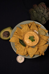 Nacho chips with cheddar cheese sauce for dipping snack mexican food style tex-mex