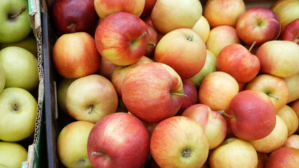 Close-up of many beautiful apples in trading boxes