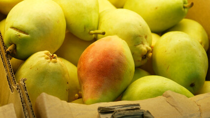 Close-up of many beautiful pears in a trading box