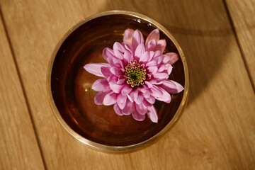 Obraz na płótnie Canvas Lotus flower in a copper bowl with water for the rite of meditation