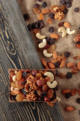 Fototapeta na wymiar Mix of nuts and raisins on a wooden table.