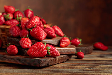 Fresh strawberries on an old wooden table.
