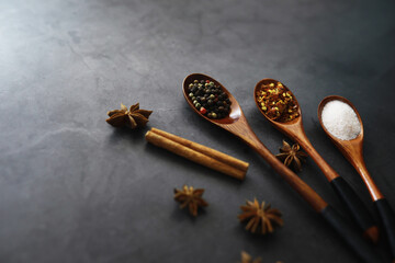 Wooden spoons with spices. A mixture of peppers and spices. Fragrant herbs for food.