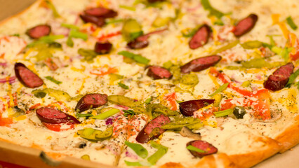 Appetizing large pizza in box. Delicious pizza with different ingredients. Close up. Concept of fast food and takeaway.