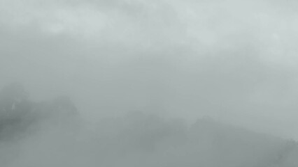 Big Buddha in the mist on the top of mountain..Another incentive to attract tourists to visit. 4k video for travel and worship concept...
