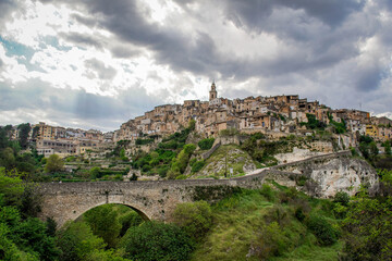 Fototapeta na wymiar General View of the Beautiful Valencian Village of Bocairent with its Stone Bridge, its Hanging Houses and its Bell Tower on a Cloudy Day. Concept of Rural Tourism in the Valencian Community