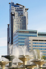 The fountain gushing with water against the background of the building in Gdynia, Poland