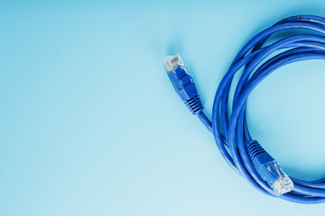 Blue Ethernet Cable Cord Patch cord on a blue background with free space