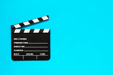 Obraz premium Clapper board isolated on blue background. Film production and movie shooting concept. Copy space for text