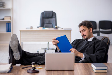 Young male judge working in the courthouse