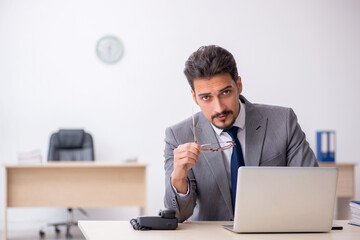 Young male employee working in the office