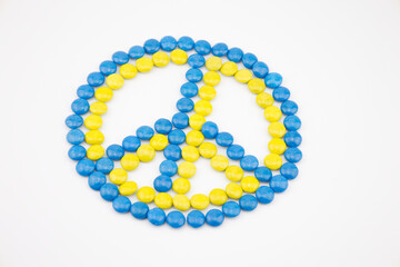 The peace sign made of circle chocolate blue and yellow color isolated on white background. Colors...