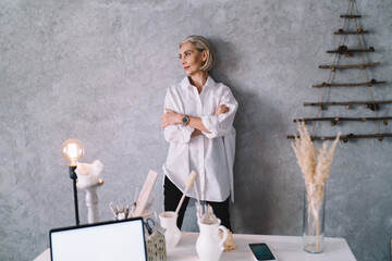 Businesswoman with crossed arms at home art studio
