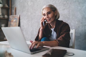 Female entrepreneur working at table at art studio