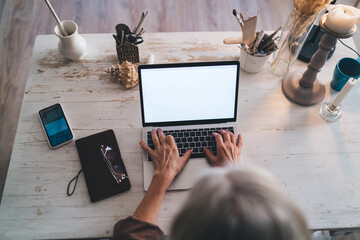 Female entrepreneur working at table at art studio
