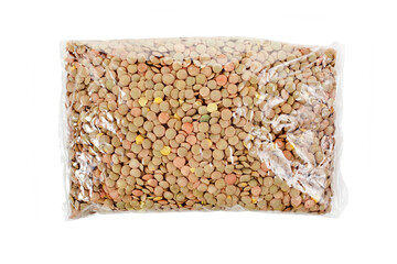 Lentils in a transparent plastic bag isolated on a white background. Top view.